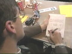 Mo is drawing a heart with "George W. Bush" inside it. Steve drew a plane.